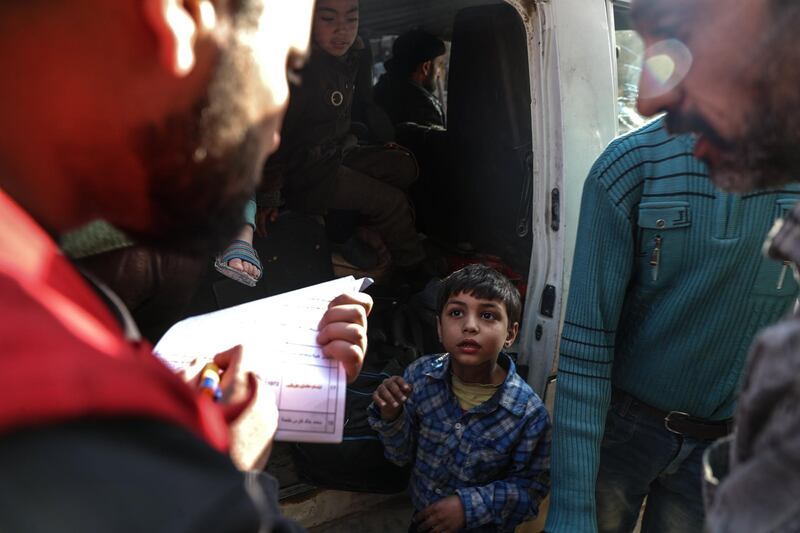 A boy prepares to enter the ambulance  during the evacuation in rebel-held Douma, Syria, on March 17, 2018. Mohammed Badra / EPA