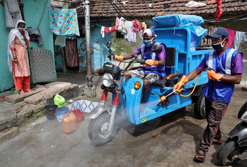 A municipal worker sprays disinfectant to sanitize a slum area to prevent the spread of the coronavirus disease in Kolkata. Reuters