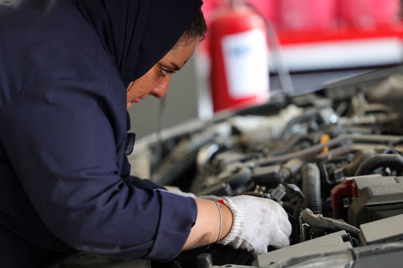 A woman working at a quick-service garage in Jeddah. AFP