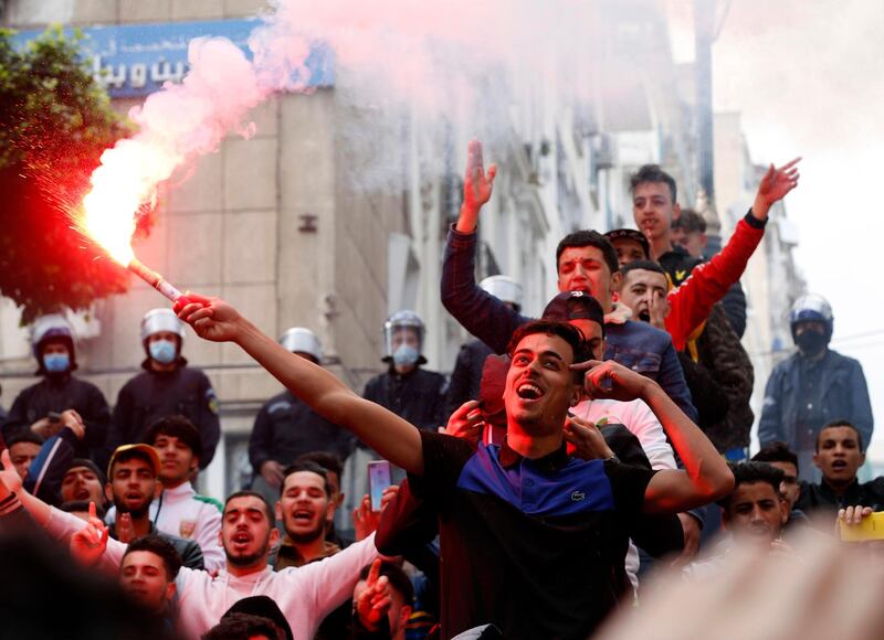 A protester waves a flare during an anti-government demonstration in Algiers, Algeria. Protesters are calling for the country's political system to be overhauled. EPA