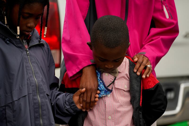 The Jacobs family prays during a vigil the day after the shooting. Reuters