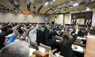 Members of the Iraqi Parliament attend a session to vote on the federal budget. AP