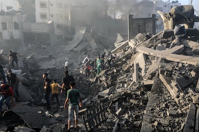 Palestinians search for bodies and survivors among the rubble of a destroyed area following Israeli air strikes in Gaza city. EPA