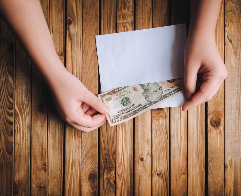 The 100-envelope challenge requires numbering 100 envelopes from one to 100 and drawing one randomly every day. The number on the envelope drawn determines the amount of cash that must be saved. Getty Images