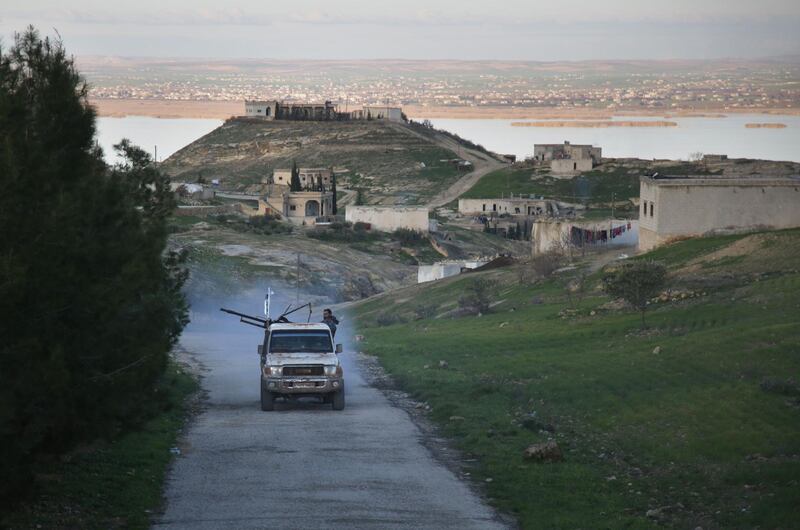 An armed vehicle driven by Turkey-backed Syrian fighters is seen in a village overlooking the Euphrates river near the rebel-held border town of Jarabulus in northern Syria, on December 29, 2018. Pro-Turkish armed groups have reinforced their presence on the outskirts of the city of Manbij in northern Syria as Ankara threatens a new offensive against Kurdish forces. / AFP / Bakr ALKASEM
