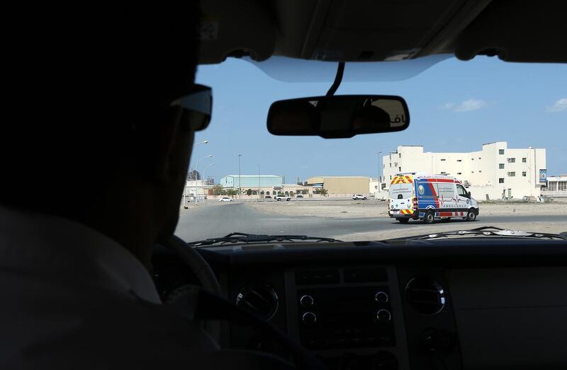 Farhan Husain, area manager of National Ambulance, follows the ambulance to the scene of an accident in Ajman. Pawan Singh / The National 