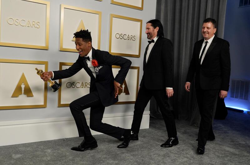 Jon Batiste, Trent Reznor and Atticus Ross, winners of the award for Best Original Score for 'Soul,' pose in the press room at the Academy Awards in Los Angeles, California. EPA