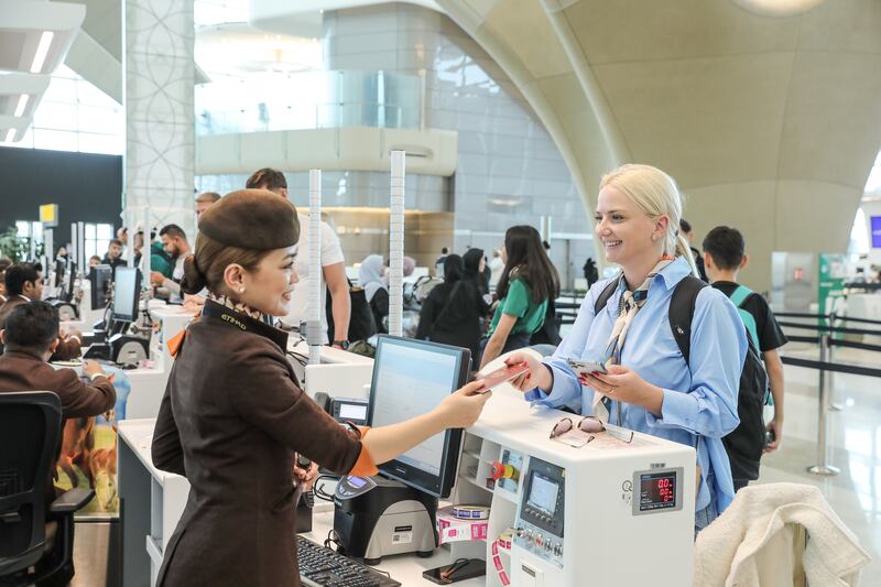 A passenger checks in at an Etihad counter on October 30, 2023. Photo: Etihad