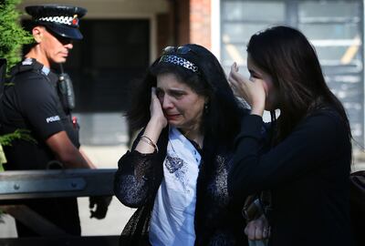 Tearful family friends outside the house of the Al Hilli family home in Claygate, England, after the killings in 2012. Getty Images