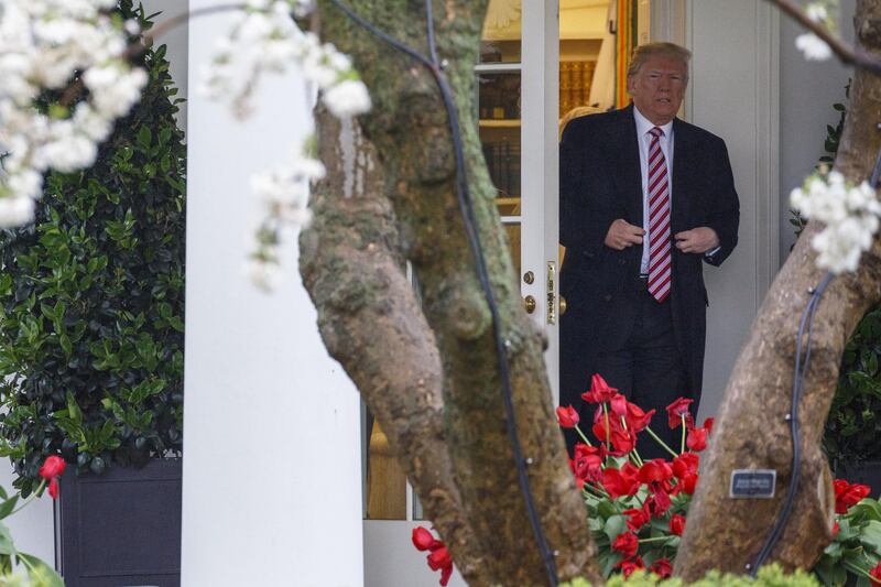 U.S. President Donald Trump exits the White House while departing for Miami from the South Lawn in Washington, D.C., U.S. on Monday, April 16, 2018. Trump accused China and Russia of devaluing their currencies, opening a new front in his argument that foreign governments are taking advantage of the U.S. economy to support their own expansions. Photographer: Joshua Roberts/Bloomberg