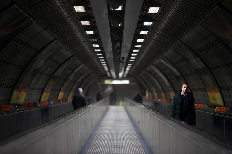 People ride on quiet escalators at Waterloo underground station in London. Reuters