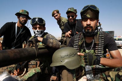 Members of the self-proclaimed eastern Libyan National Army (LNA) special forces gather in the city of Benghazi, on their way to reportedly back up fellow LNA fighters on the frontline west of the city of Sirte, facing forces loyal to the UN-recognised Government of National Accord (GNA), on June 18, 2020.  The resurgent GNA has vowed to push on for Sirte, late Libyan leader Moamer Kadhafi's hometown and the last major settlement before the traditional boundary between western Libya and Haftar's stronghold in the east. / AFP / Abdullah DOMA
