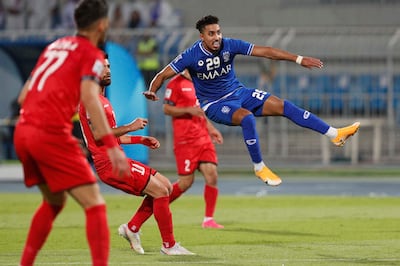 Al Hilal midfielder Salem Al Dawsari, right, shoots in the AFC Champions League quarter-final against Persepolis. AFP