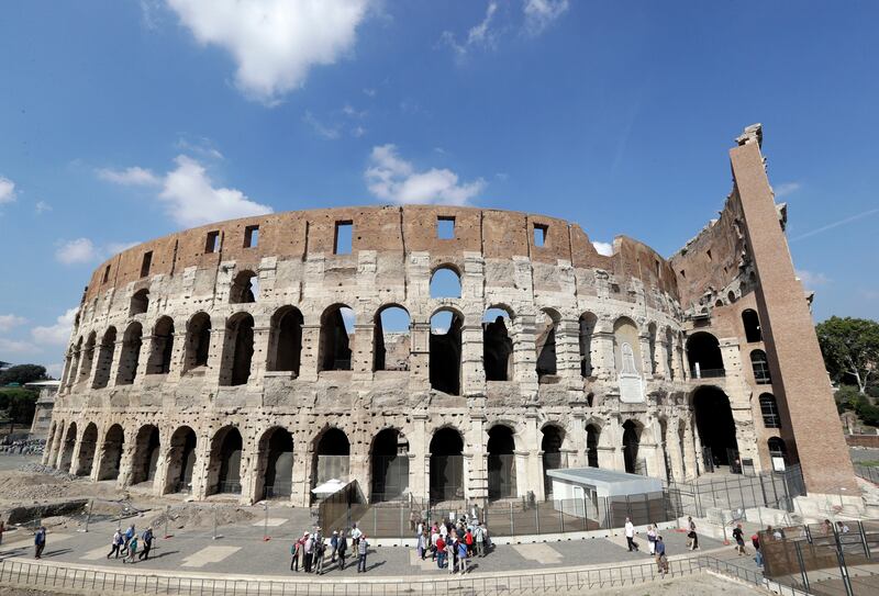 Tourists are seen visiting the ancient Colosseum, in Rome. Andrew Medichini / AP Photo