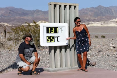 DEATH VALLEY NATIONAL PARK, CALIFORNIA - AUGUST 17: Visitors gather for a photo in front of an unofficial thermometer at Furnace Creek Visitor Center on August 17, 2020 in Death Valley National Park, California. The temperature reached 130 degrees at Death Valley National Park on August 16, hitting what may be the hottest temperature recorded on Earth since at least 1913, according to the National Weather Service. Park visitors have been warned, Travel prepared to survive.   Mario Tama/Getty Images/AFP
== FOR NEWSPAPERS, INTERNET, TELCOS & TELEVISION USE ONLY ==
