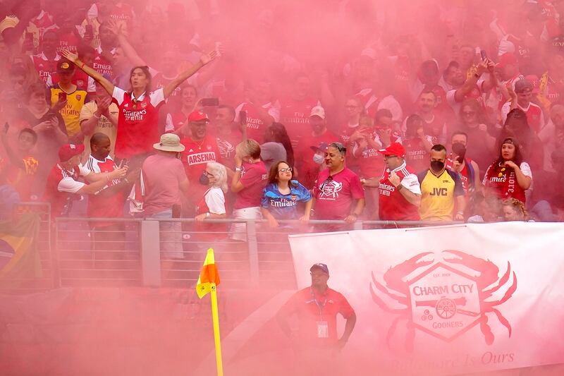 Arsenal fans celebrate a goal on Saturday. AP