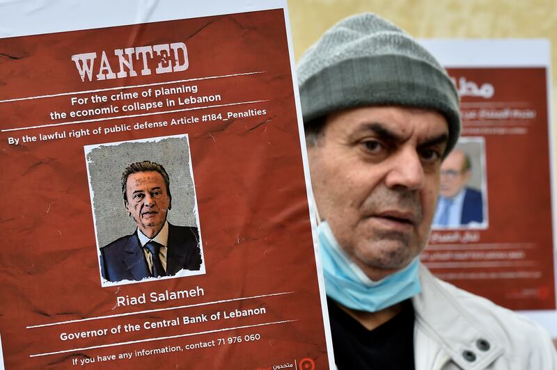 A poster featuring the image of Lebanon central bank governor Riad Salameh during a protest in outside the French embassy in Beirut, Lebanon, in January 2022. Mr Salameh told Swiss television his detained brother Raja did not profit from public funds. EPA