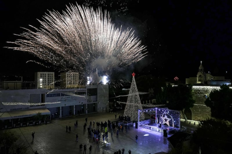 This picture taken on December 5, 2020 shows a fireworks display during the lighting of the Christmas tree in the biblical city of Bethlehem in the occupied West Bank, closed to the public due to the COVID-19 coronavirus pandemic. / AFP / EMMANUEL DUNAND
