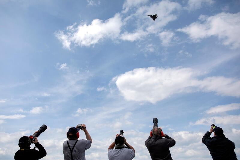 Plane spotters take pictures of a French built Dassault Rafale fighter jet during a test and evaluation day at the Swiss Army airbase, in Payerne, Switzerland.    EPA