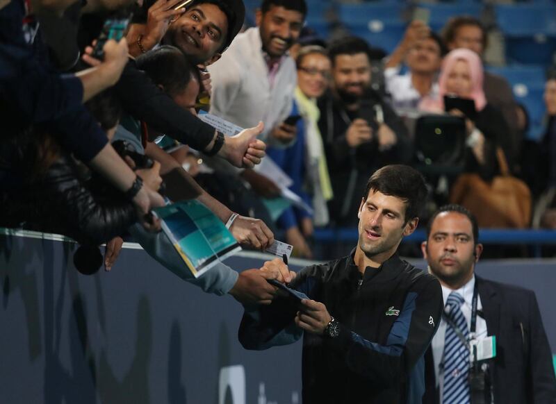 Novak Djokovic, an obvious crowd favourite here, signs autographs moments after winning the championship. Suhaib Salem / Reuters