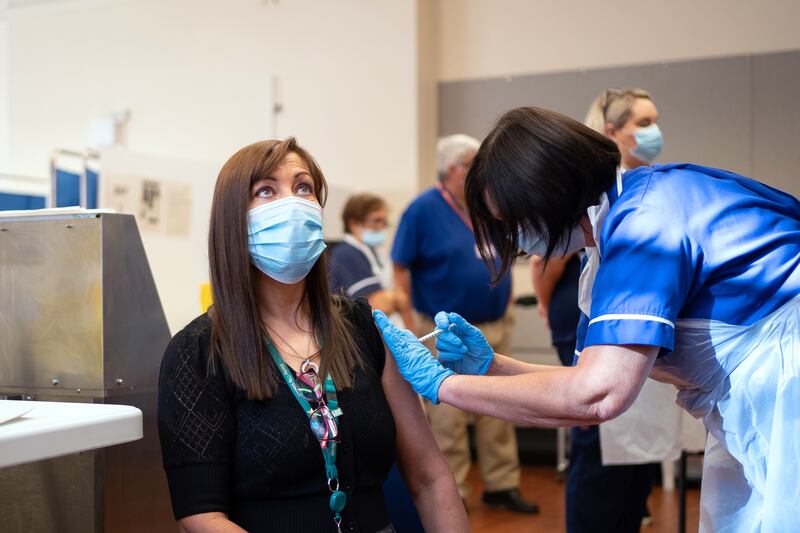 A woman receives a Covid-19 vaccine booster in Derby, England. A WHO official has issued a warning that there is still 'a long way to go' in the fight to keep the virus under control. PA