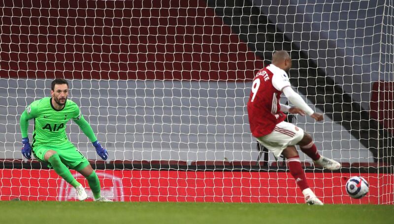 Arsenal's Alexandre Lacazette scores from the penalty spot against Tottenham Hotspur at the Emirates Stadium on Sunday, March 14, 2021. AP