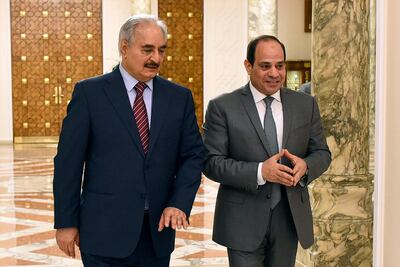 FILE - In this May 9, 2019 file photo, provided by Egypt's presidency media office, Egyptian President Abdel-Fattah el-Sissi, right, walks with military commander Khalifa Hifter, the head of the self-styled Libyan National Army, in Cairo, Egypt. The Egyptian Parliament is likely to vote Monday, July 20, 2020, to authorize the country's president to deploy troops to war-torn Libya if Turkey-backed forces allied with the U.N.-supported government in Tripoli move to retake the strategic coastal city of Sirte. The country is now split between a government in the east, allied with Hifter, and one in Tripoli, in the west, supported by the United Nations. Along with Egypt, Hifter is also backed by the United Arab Emirates and Russia, while the in addition to Turkey, the Tripoli forces are aided by Qatar and Italy. (Egyptian Presidency Media office via AP, File)