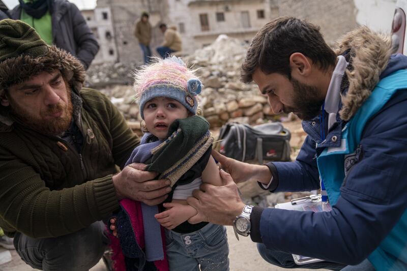 Amirah is screened for malnutrition by a Unicef-supported mobile health team worker in Aleppo. PA