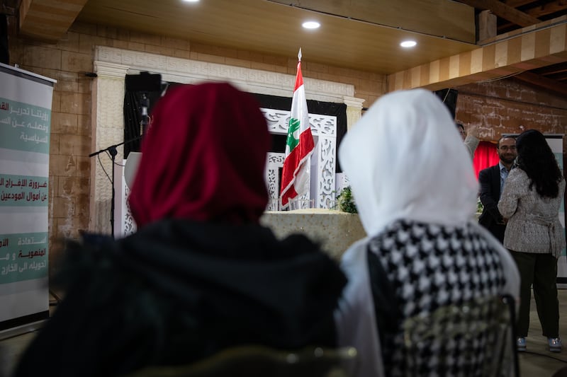 Two supporters wait for an opposition rally for South Lebanon District 2 to begin in a restaurant hall in Sarafand. Local men and women gathered to intimidate those arriving for the rally by blocking the road, throwing stones, beating supporters and even firing a gun in the air. Leader of the Shia Amal party, Nabih Berri, is an MP in the same district.