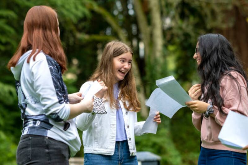 Sophie Thomas, centre, after opening her results at Ffynone House School in Swansea.