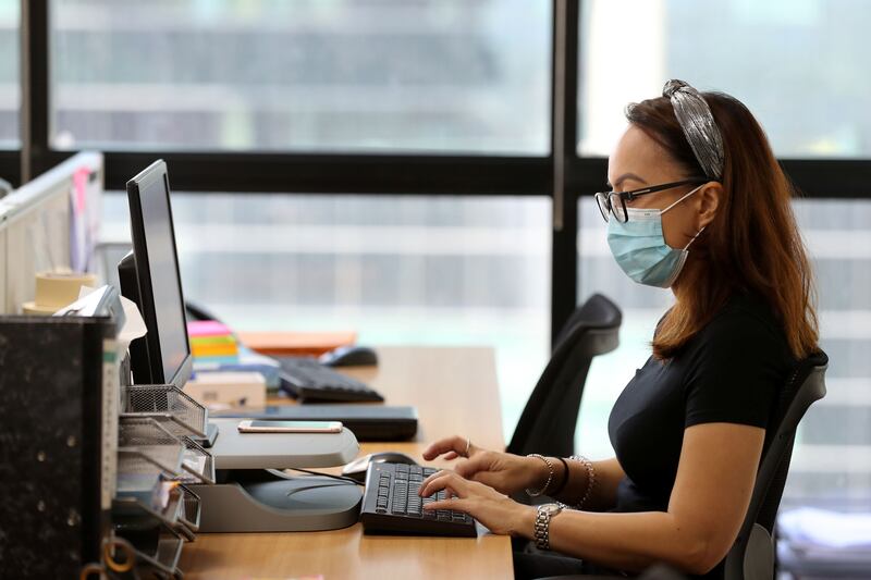 Dubai, United Arab Emirates - Reporter: Patrick Ryan: News. Kristine Angus works at her desk with her mask on. How firms are social distancing staff who are back in the office working. Thursday, May 21st, 2020. Dubai. Chris Whiteoak / The National