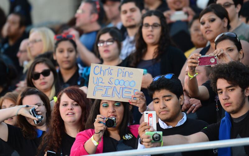 Fans show their support for Chris Pine, who plays the role of 'Kirk', as he poses on arrival for the Los Angeles premiere of the movie 'Star Trek Into Darkness" in Hollywood, California on May 14, 2013. The film opens nationwide on May 15. AFP PHOTO/Frederic J. BROWN
 *** Local Caption ***  116694-01-08.jpg