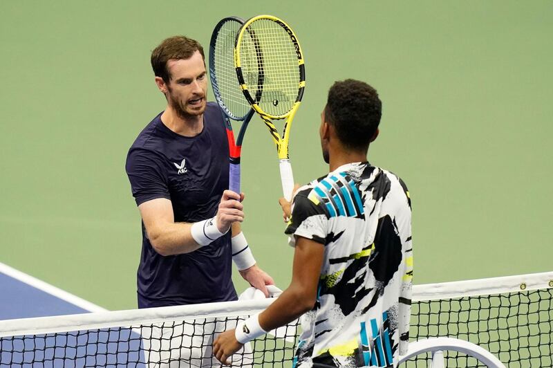 Felix Auger-Aliassime and Andy Murray tap rackets after their US Open second round match. PA