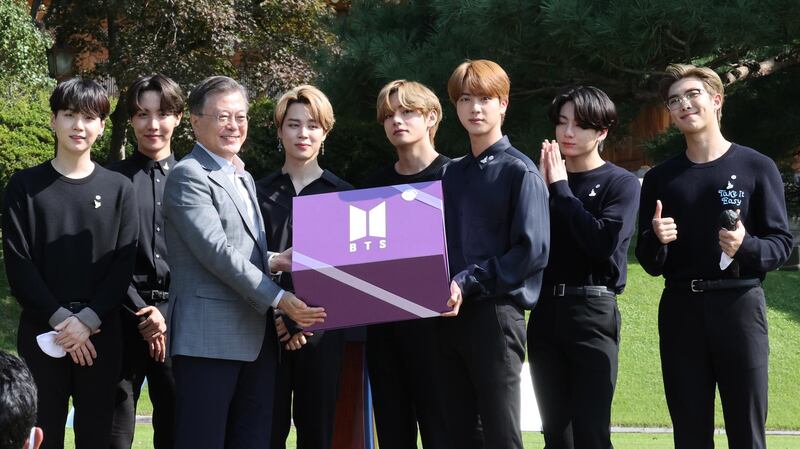 BTS present a purple gift box to President Moon Jae-in during the inaugural Youth Day event in Seoul on September 19, 2020. EPA