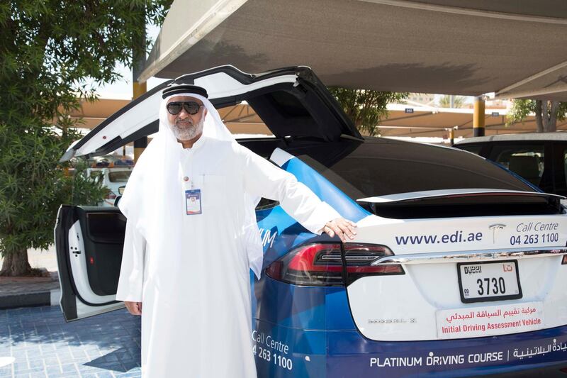 Dubai, United Arab Emirates - Taleb Mahmoud Ayub, Head of Operations next to a Tesla car at the Emirates Driving Institute, Dubai.  Leslie Pableo for The National
