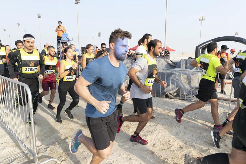 ABU DHABI, UNITED ARAB EMIRATES. 11 OCTOBER 2019. The Tough Mudder sports event held on Hudayriat Island in Abu Dhabi. Participants set off on the first leg of the race towards the first obstacle. (Photo: Antonie Robertson/The National) Journalist: None. Section: National.
