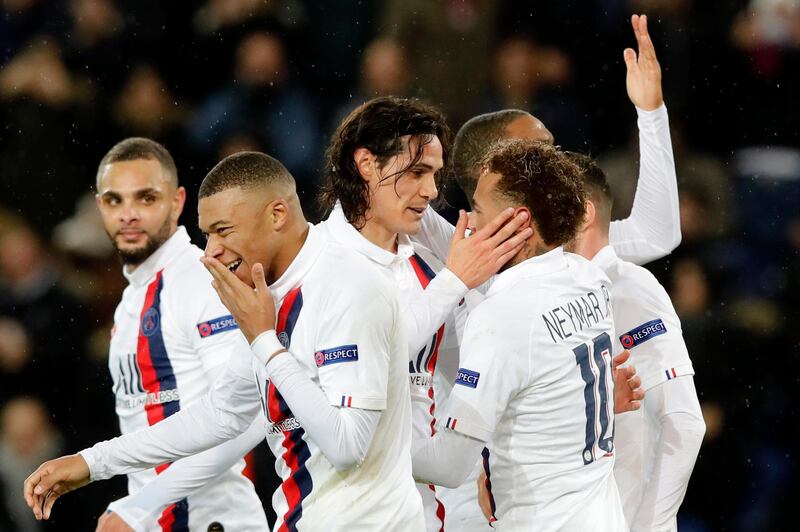 PSG's Edinson Cavani, centre, celebrates with Neymar, right, after scoring his side's fifth goal. AP