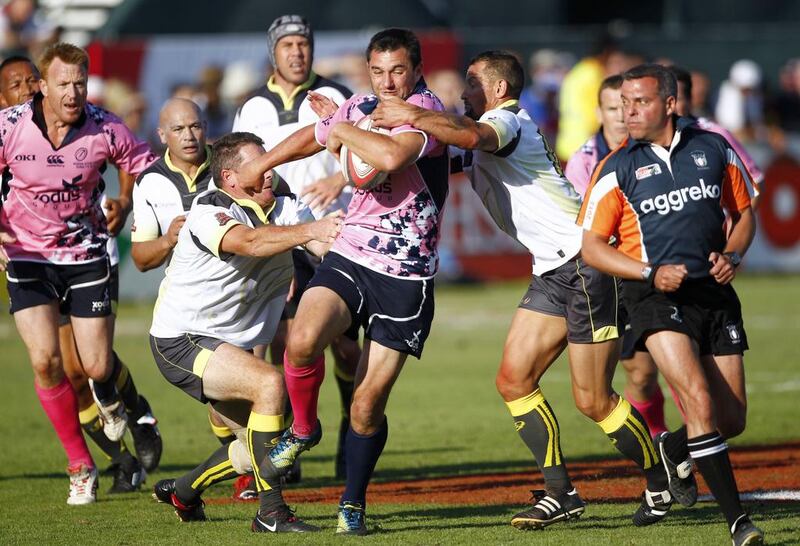 Xodus Steelers, in pink, were not to be stopped by J9 Legends on their way to the Action from the Dubai Rugby Sevens International Veterans title on Saturday  at The Sevens, Dubai. Jake Badger for The National