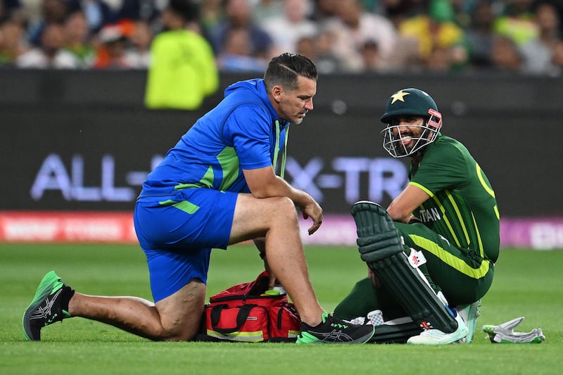 Shan Masood of Pakistan receives medical attention after being hit on the helmet. EPA