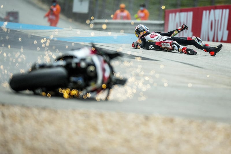 TOPSHOT - LCR Honda IDEMITSU's Japanese rider Takaaki Nakagami crashes in the second MotoGP free practice session of the Portuguese Grand Prix at the Algarve International Circuit in Portimao, on April 16, 2021. / AFP / PATRICIA DE MELO MOREIRA
