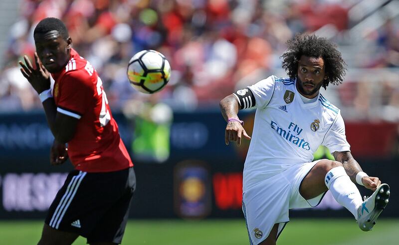 Real Madrid's Marcelo, right, kicks the ball away from Manchester United's Timothy Fosu-Mensah. Ben Margot / AP Photo