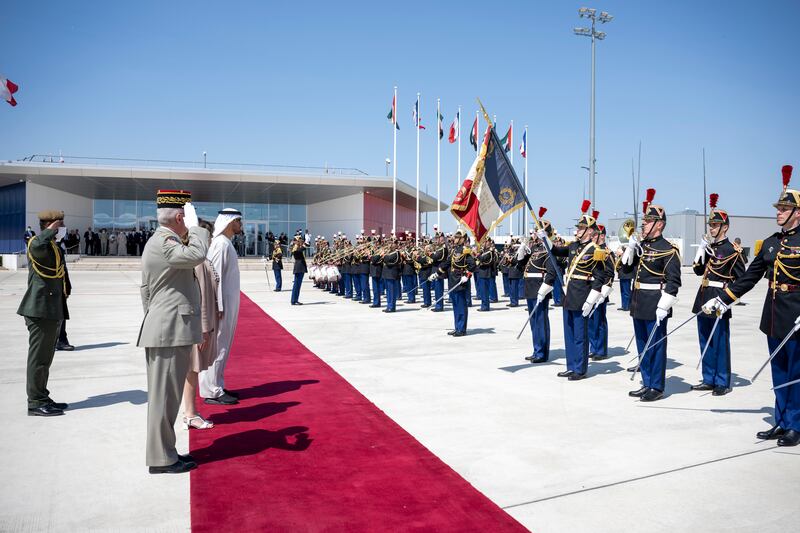 Sheikh Mohamed stands for the national anthems. Photo: Presidential Court