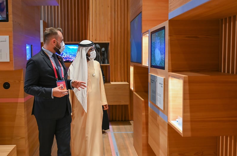 An official shows Sheikh Mohammed displays at the Poland pavilion.