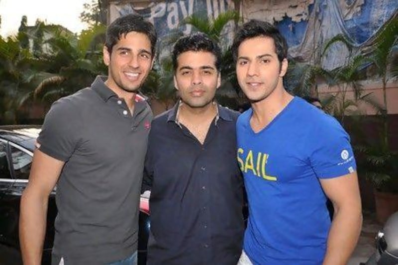 The Student of the Year director Karan Johar, centre, with the actors Sidharth Malhotra and Varun Dhawan, says he is not ready to announce his next project. IANS