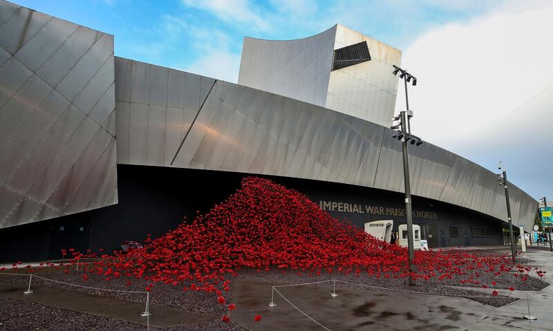 The sweeping arch of red poppy flowers sculpture entitled Wave by artist Paul Cummins and designer Tom Piper, at Imperial War Museum North in Manchester. AP