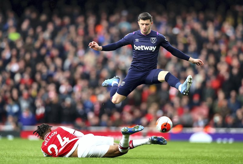 LONDON, ENGLAND - MARCH 07: Aaron Cresswell of West Ham United and Reiss Nelson of Arsenal in action  during the Premier League match between Arsenal FC and West Ham United at Emirates Stadium on March 07, 2020 in London, United Kingdom. (Photo by Chloe Knott - Danehouse/Getty Images)