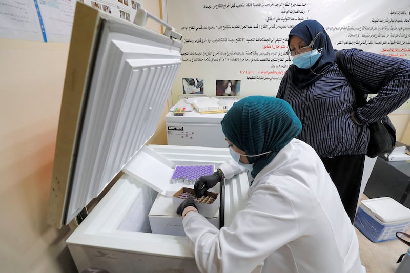 A medical worker unpacks a box of Pfizer-BioNTech coronavirus vaccine at a vaccination centre in Iraq's capital, Baghdad.