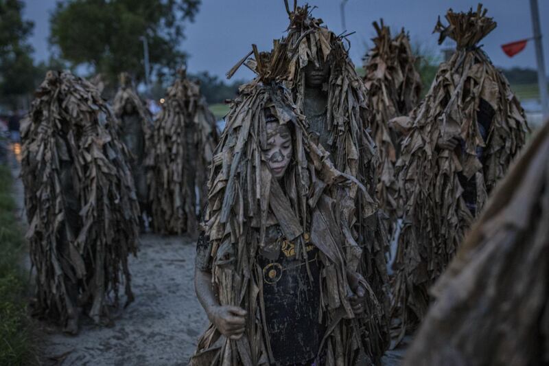 Devotees covered in mud and dried banana leaves take part in the Taong Putik ("mud people") Festival  in the village of Bibiclat in Aliaga town, Nueva Ecija province, Philippines. Each year, the residents of Bibiclat village in Aliaga town celebrate the Feast of Saint John by covering themselves in mud, dried banana leaves, vines, and twigs as part of a little-known Catholic festival. Getty Images