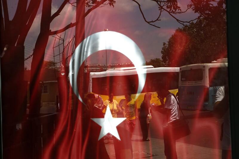 A Turkish draped in a window at a bus station in Istanbul on July 25, 2016. Petros Karadjias / AP Photo