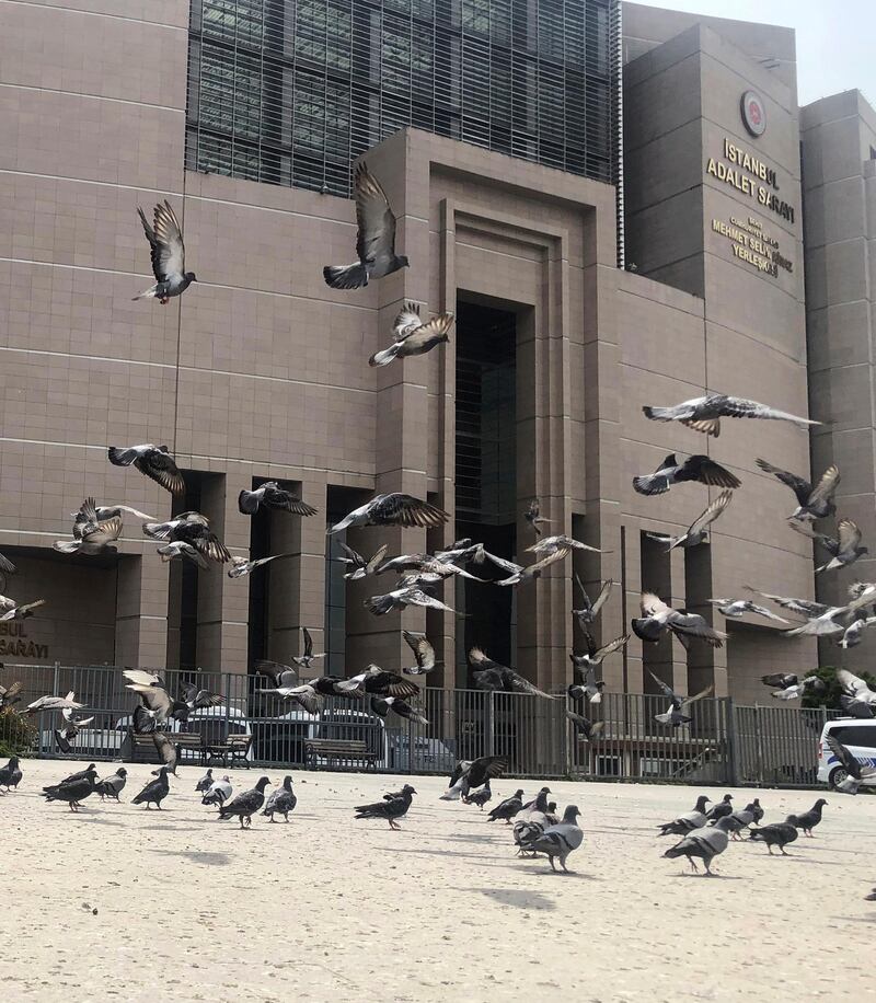 Pigeons fly outside the main Justice Palace in Istanbul, as the trial begins against Metin Topuz, a Turkish employee of the US Consulate in Istanbul charged with espionage and attempting to overthrow the Turkish government.  AP Photo